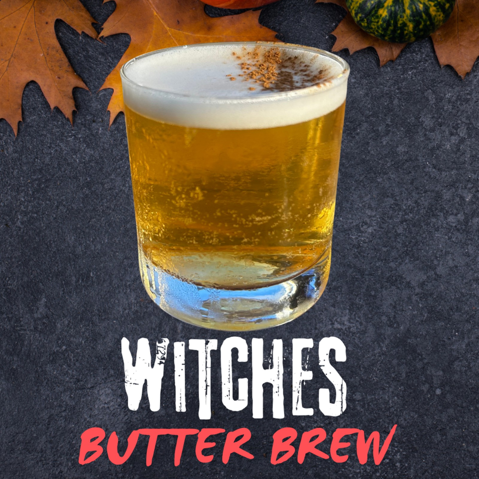 Golden butter beer in a clear glass topped with foam and spices, displayed against autumn leaves with “Witches Butter Brew” text.